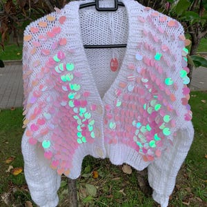 hand-knitted white cardigan with large pink trim